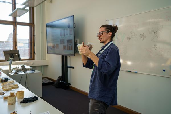 Peter Petros comparing two bags of paludiculture feedstock during the workshop