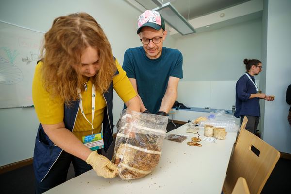 Workshop participants handling the cultivation bag and mycelium samples